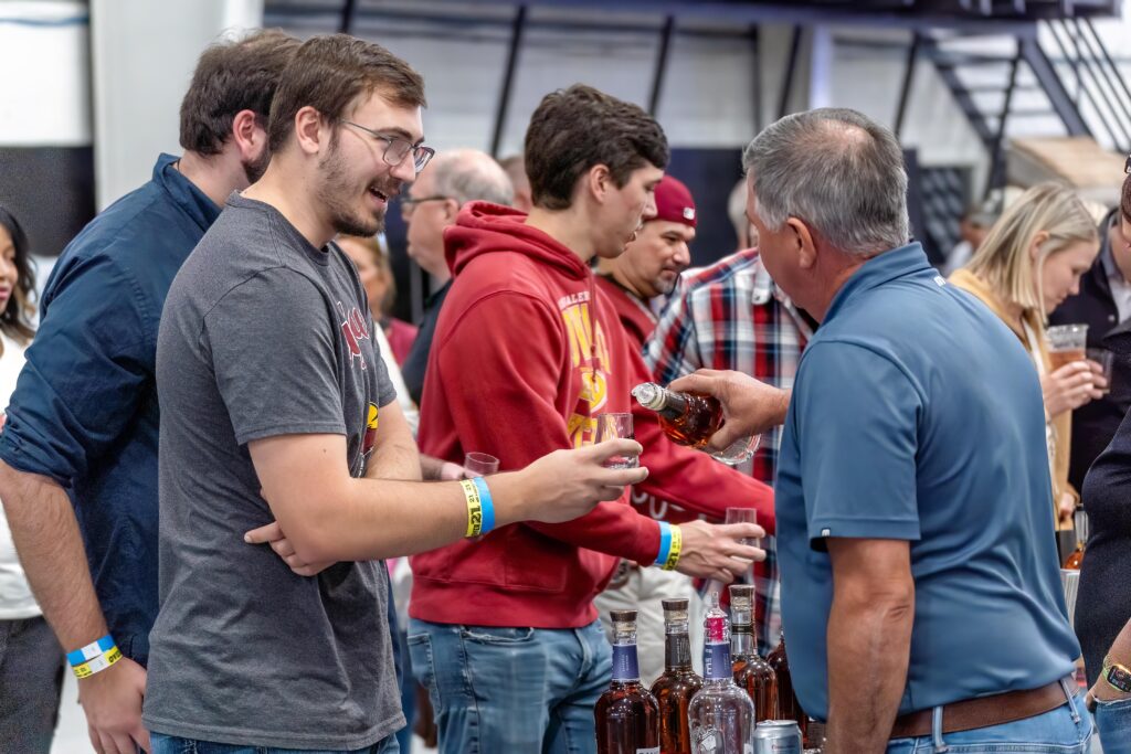Attendees networking and tasting products at a branded event
