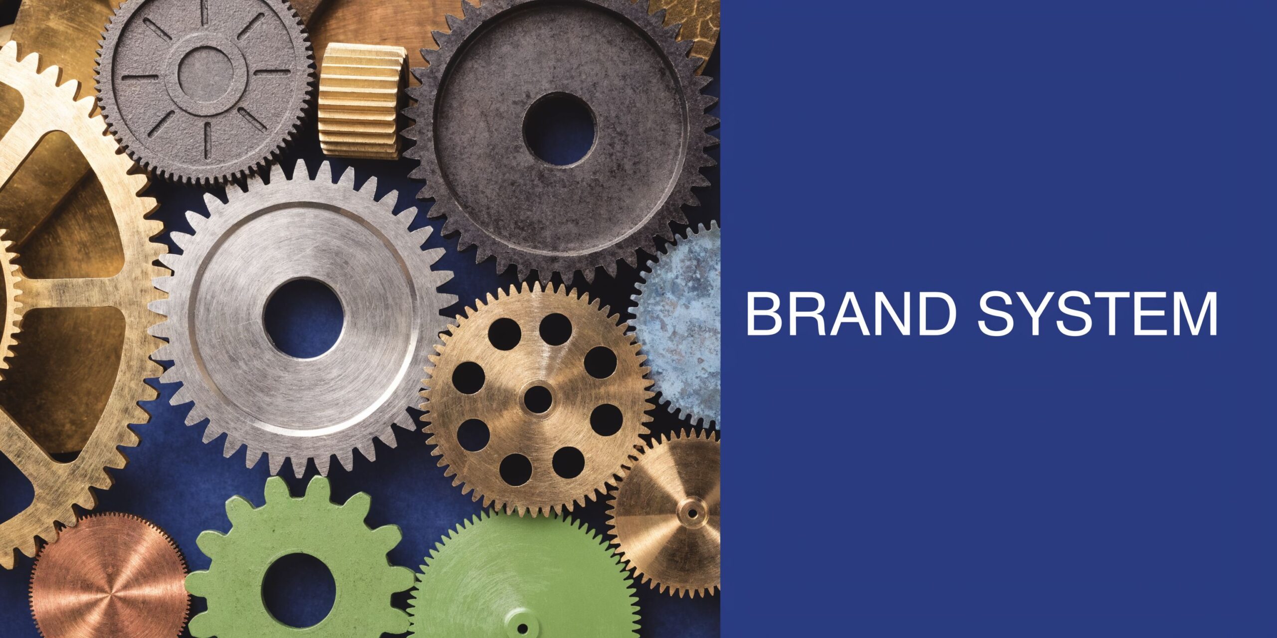 A flat lay of various industrial metal and colored plastic gears arranged on a dark blue background.